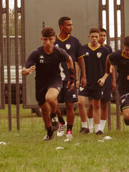 Young player training on a football field.