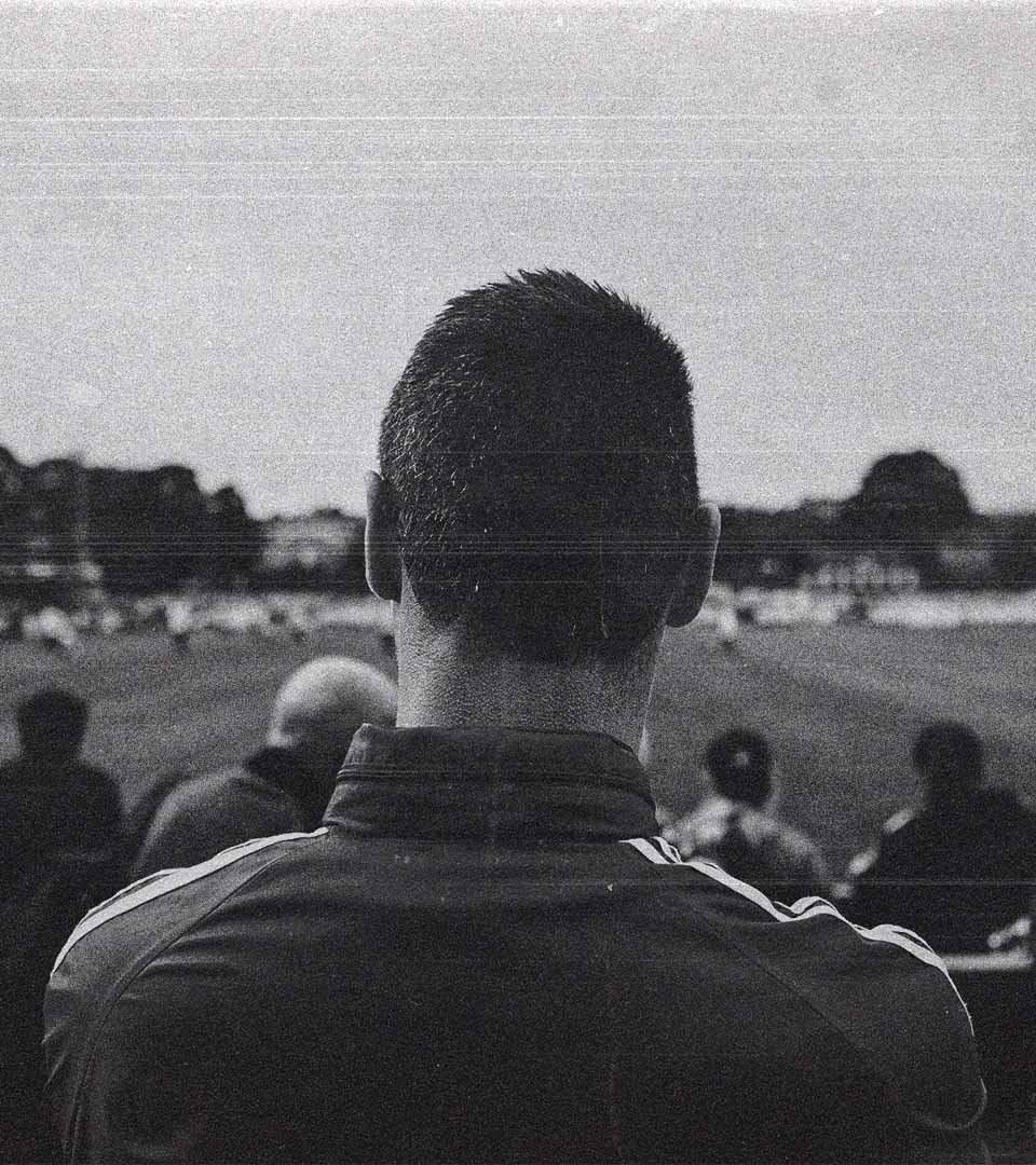 A man in the stands watching the players.