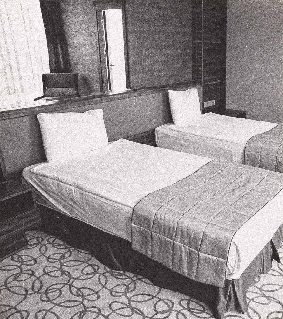 A hotel room with two beds.